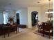 Bright living and dining area with neutral carpeting and a view of the kitchen at 4458 Maverick St, North Port, FL 34288