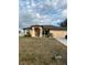 Single-story house with beige exterior, brown roof, and a two-car garage at 4458 Maverick St, North Port, FL 34288