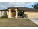 One-story home with a beige exterior, brown roof, and attached garage at 4458 Maverick St, North Port, FL 34288