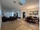 Spacious living and dining area with neutral carpeting and a view of the kitchen at 4458 Maverick St, North Port, FL 34288