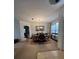 Dining area with a dark wood table and chairs, along with neutral carpeting at 4458 Maverick St, North Port, FL 34288