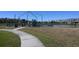 A community playground with swings and climbing equipment for Gathering fun near the lake at 16321 Treasure Point Dr, Wimauma, FL 33598