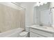 Full bathroom featuring a bathtub, shower, and a single sink vanity at 9413 Ballaster Pointe Loop, Parrish, FL 34219