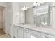 Bright bathroom featuring double sinks, quartz countertops, and a glass-enclosed shower at 9413 Ballaster Pointe Loop, Parrish, FL 34219