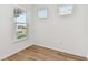 Minimalist bedroom with hardwood floors and multiple windows with blinds at 9413 Ballaster Pointe Loop, Parrish, FL 34219
