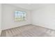 Neutral bedroom with carpet flooring and a large window offering natural light at 9413 Ballaster Pointe Loop, Parrish, FL 34219