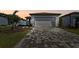 Charming home featuring a spacious two-car garage, brick driveway, and a well manicured lawn at 9413 Ballaster Pointe Loop, Parrish, FL 34219