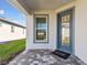 Inviting front entryway with a glass-paneled blue door and a brick-paved porch at 9413 Ballaster Pointe Loop, Parrish, FL 34219