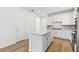 Open-concept kitchen showcasing a center island, stainless appliances, and abundant cabinet space at 9413 Ballaster Pointe Loop, Parrish, FL 34219