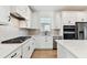 Modern kitchen with white cabinets, stainless appliances, and a gas range at 9413 Ballaster Pointe Loop, Parrish, FL 34219