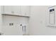 Bright laundry room with white cabinets, and hookups for a washer and dryer at 9413 Ballaster Pointe Loop, Parrish, FL 34219