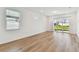 Bright living room with wood flooring and sliding glass doors to the backyard at 9413 Ballaster Pointe Loop, Parrish, FL 34219