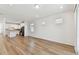 Open living space with wood flooring connecting to a modern kitchen at 9413 Ballaster Pointe Loop, Parrish, FL 34219