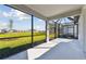 Screened-in patio overlooking a manicured lawn and pond at 9413 Ballaster Pointe Loop, Parrish, FL 34219