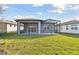 Backyard featuring a covered patio and a screened in lanai at 9421 Ballaster Pointe Loop, Parrish, FL 34219