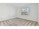 Bright bedroom features neutral carpet, fresh white walls, and a window with natural light at 9421 Ballaster Pointe Loop, Parrish, FL 34219