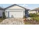 Charming single-Gathering home with a two-car garage and a beautifully landscaped front yard and walkway at 9421 Ballaster Pointe Loop, Parrish, FL 34219