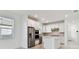 Modern kitchen featuring stainless steel appliances, white cabinetry, and a center island with a white countertop at 9421 Ballaster Pointe Loop, Parrish, FL 34219
