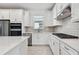 Bright kitchen with stainless steel appliances, stylish cabinetry, and gas range at 9421 Ballaster Pointe Loop, Parrish, FL 34219