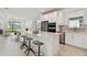 Bright, open kitchen with stainless steel appliances and a large island with bar stool seating at 9421 Ballaster Pointe Loop, Parrish, FL 34219