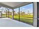 Screened lanai boasts a view of the green backyard at 9421 Ballaster Pointe Loop, Parrish, FL 34219
