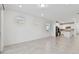 Open concept living space with tile flooring, multiple windows, and easy access to the kitchen at 9421 Ballaster Pointe Loop, Parrish, FL 34219