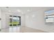 Bright living area with large sliding glass doors, tile floors, and neutral paint, offering a seamless transition to outdoor living at 9421 Ballaster Pointe Loop, Parrish, FL 34219