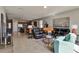 Open concept living room with sectional sofa and view into kitchen at 16321 Treasure Point Dr, Wimauma, FL 33598