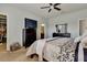Well-lit bedroom with a dresser, large bed, and closet at 16321 Treasure Point Dr, Wimauma, FL 33598