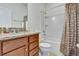 Clean bathroom with granite countertop, tub shower, and updated fixtures at 16321 Treasure Point Dr, Wimauma, FL 33598