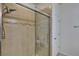 Clean bathroom with a walk-in shower and glass enclosure at 16321 Treasure Point Dr, Wimauma, FL 33598