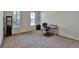 Spacious home office with carpeted floor and large windows at 16321 Treasure Point Dr, Wimauma, FL 33598