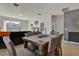 Bright dining area with a wooden table and four chairs, near the living room at 16321 Treasure Point Dr, Wimauma, FL 33598