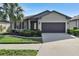 House exterior view, showcasing front yard and driveway at 16321 Treasure Point Dr, Wimauma, FL 33598