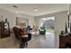 Living room features a comfortable sectional sofa and sliding glass doors to backyard at 16321 Treasure Point Dr, Wimauma, FL 33598