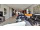 Open living room with sectional sofa, coffee table and view of kitchen at 16321 Treasure Point Dr, Wimauma, FL 33598