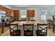 Kitchen island with granite countertop and seating for three at 16321 Treasure Point Dr, Wimauma, FL 33598