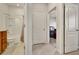 Bright hallway with tile flooring leading to a bedroom and bathroom at 16321 Treasure Point Dr, Wimauma, FL 33598