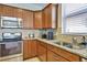 Kitchen features a corner sink, granite countertops, and modern appliances at 16321 Treasure Point Dr, Wimauma, FL 33598