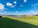Picture of a lush green backyard with a scenic view of a tranquil lake at 11818 Tetrafin Dr, Riverview, FL 33579