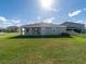 A large, well-maintained backyard featuring a spacious lawn and partial view of neighboring homes at 11818 Tetrafin Dr, Riverview, FL 33579