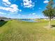 Expansive backyard featuring a scenic pond view and lush green grass at 11818 Tetrafin Dr, Riverview, FL 33579