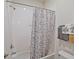 Bright bathroom with white tiled walls, shower/tub and decorative curtain at 11818 Tetrafin Dr, Riverview, FL 33579