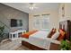 Bedroom features accent wall and large windows, with a comfortable bed at 11818 Tetrafin Dr, Riverview, FL 33579