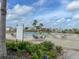 A community pool features lounge chairs, tables, and chairs, all surrounded by lush landscaping and palm trees at 11818 Tetrafin Dr, Riverview, FL 33579