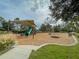 A neighborhood playground featuring slides, swings, and a merry-go-round for to play and have fun at 11818 Tetrafin Dr, Riverview, FL 33579