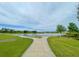 Scenic view of a peaceful pond with a walking path, perfect for enjoying nature at 11818 Tetrafin Dr, Riverview, FL 33579