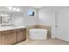 Bright bathroom features a soaking tub, modern vanity, and large mirror creating a relaxing space at 2509 N Glenwood Dr, Tampa, FL 33602