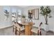 Bright dining room features modern oval wood table and stylish chairs illuminated by natural light at 2509 N Glenwood Dr, Tampa, FL 33602
