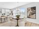 Bright dining area features modern chandelier, large windows, and stylish, comfortable white chairs at 2509 N Glenwood Dr, Tampa, FL 33602